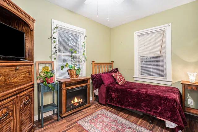 a living room with a bed furniture and a flat screen tv