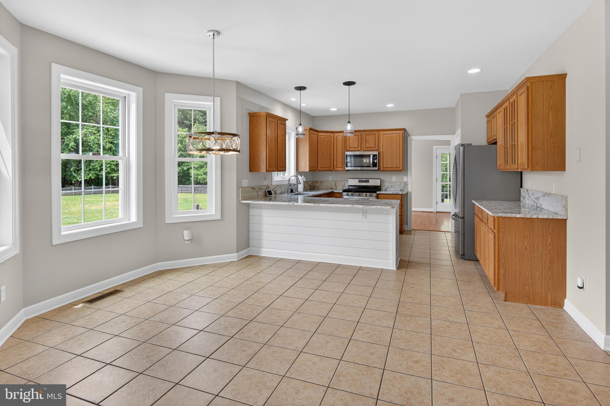 337 Roe Ingleside Road Centreville, MD 21617 - Photo 26 of 56 a kitchen with stainless steel appliances granite countertop a refrigerator sink and microwave
