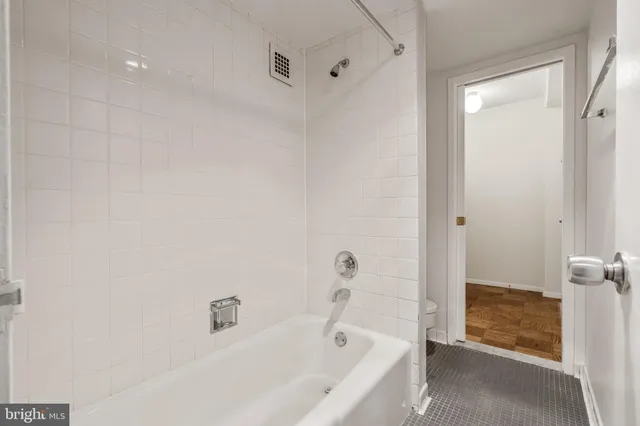 a bathroom with a bathtub and shower
