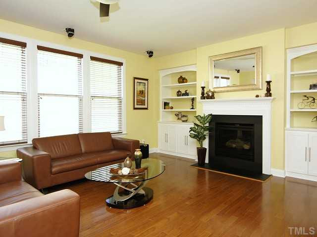 13002 Edsel Drive Raleigh, NC 27613 - Photo 5 of 24 Family room with gas fireplace, built-ins, and remote-controlled ceiling fan. Den/Family/Great Room