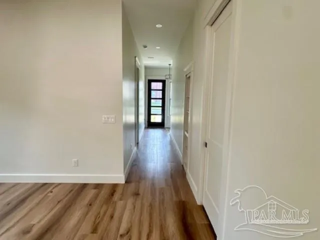 a view of room with a ceiling fan and wooden floor