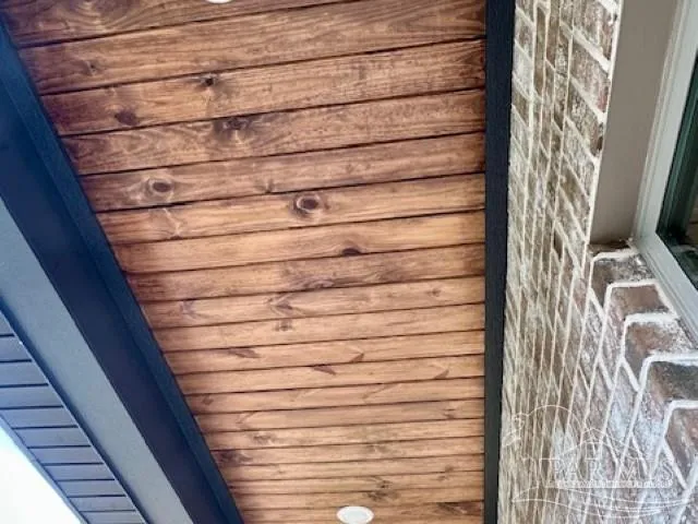 a kitchen with stainless steel appliances kitchen island granite countertop a stove a refrigerator a sink and a microwave with wooden floor