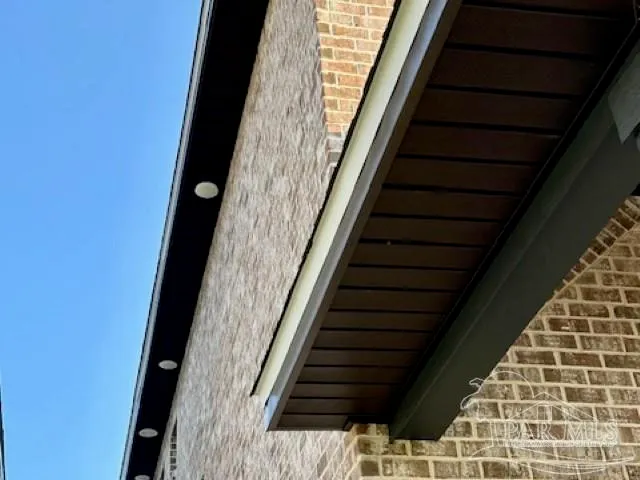 an empty room with wooden floor a ceiling fan and windows