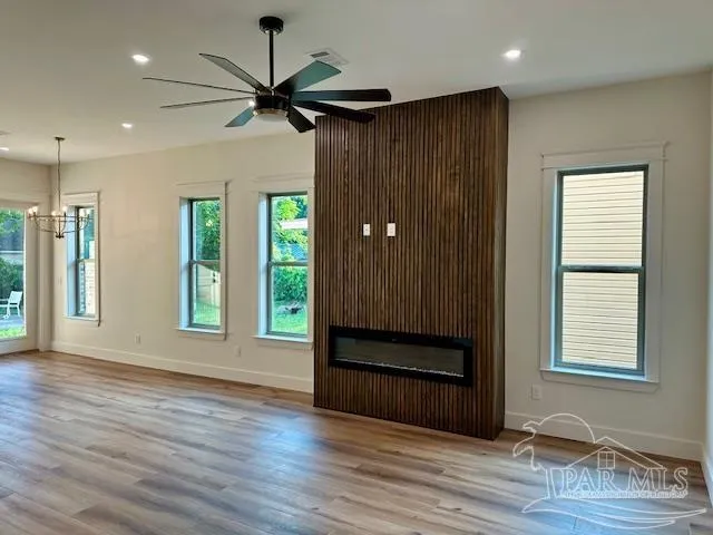 a kitchen with a sink cabinets and wooden floor