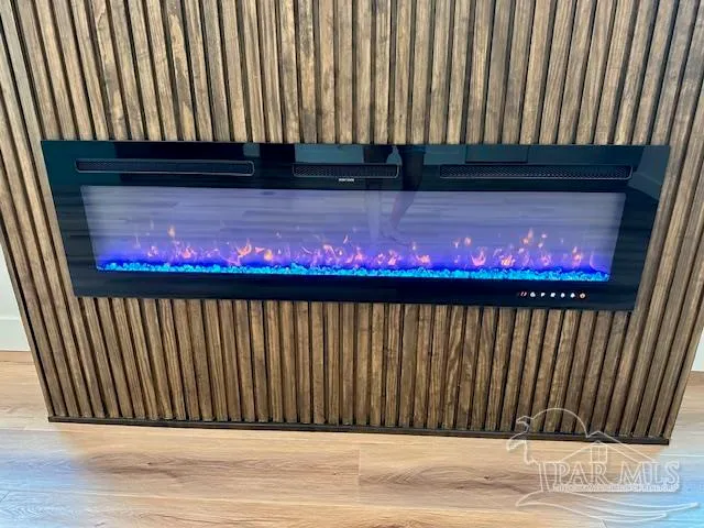 a kitchen with stainless steel appliances granite countertop a sink a stove and a wooden floors