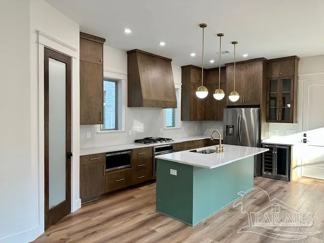 a kitchen with kitchen island a stove and a refrigerator