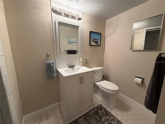 a bathroom with a sink toilet and mirror
