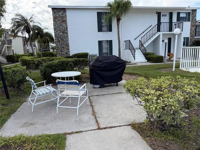 a view of a chairs and table in backyard