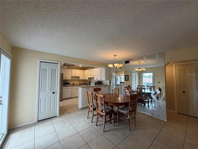 a view of a dining room with furniture and chandelier