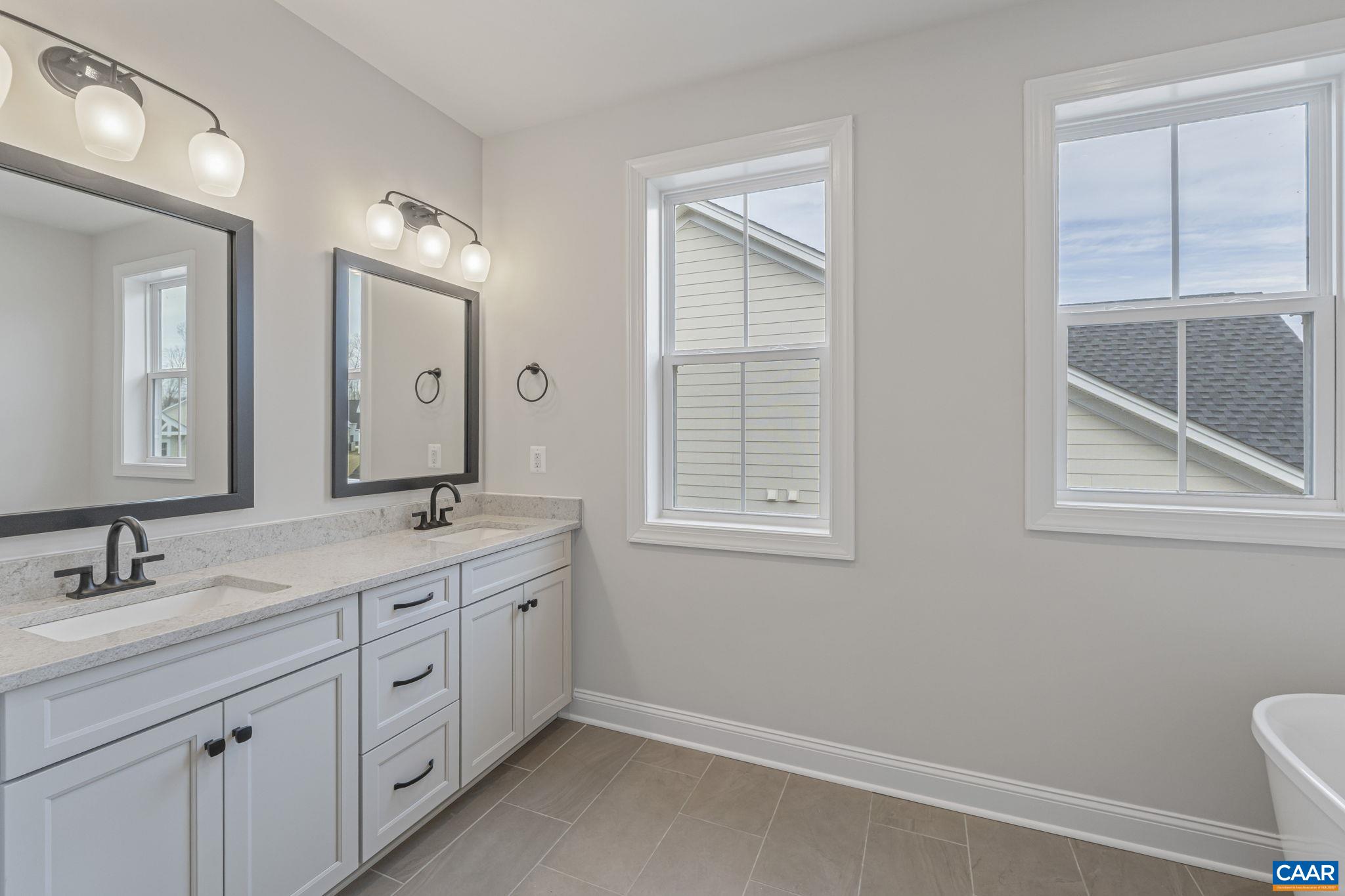 62 A Springdale Road Waynesboro, VA 22980 - Photo 16 of 37 a spacious bathroom with a double vanity sink a mirror and a toilet