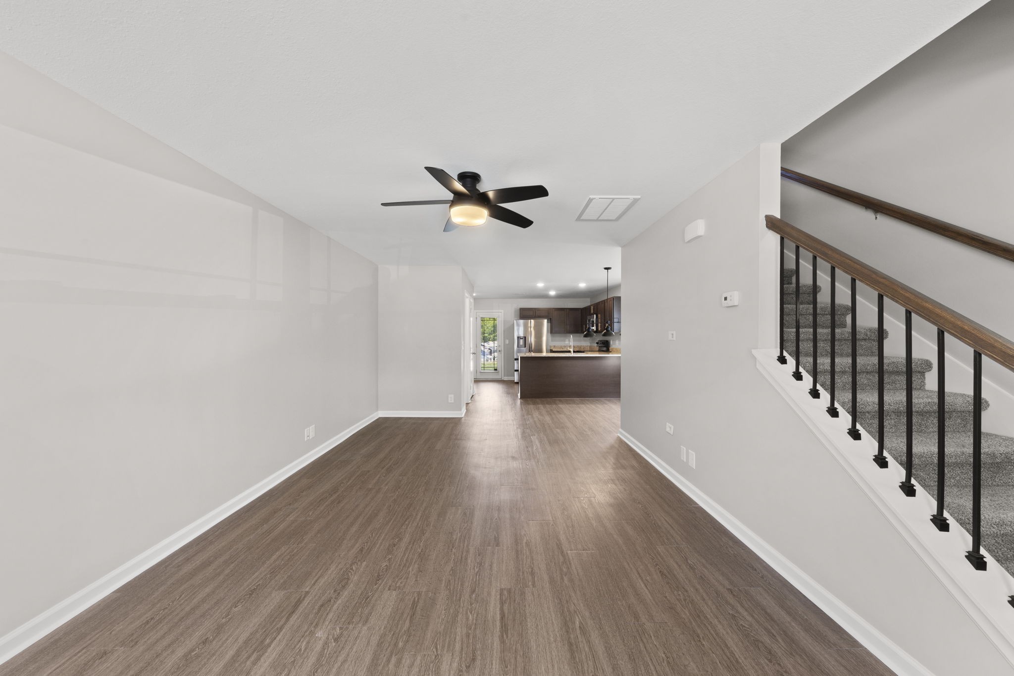 119 Davis Ridge Lane Clarksville, TN 37040 - Photo 7 of 30 a view of a livingroom with wooden floor a ceiling fan and staircase
