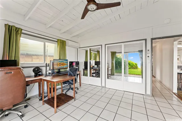 a view of a workspace with furniture and a window