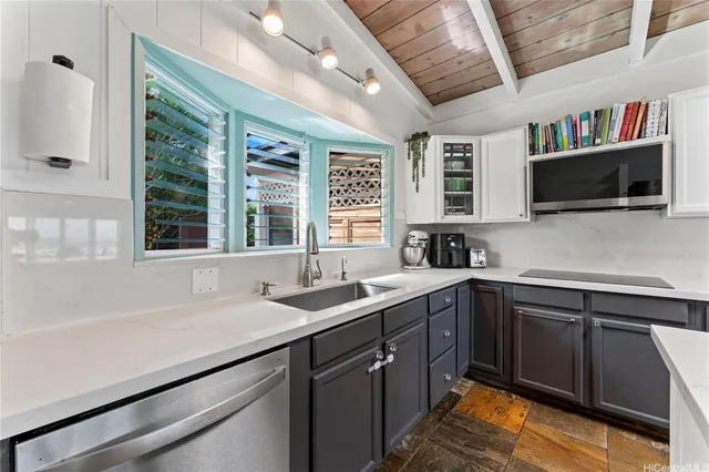 a kitchen with a sink and large window