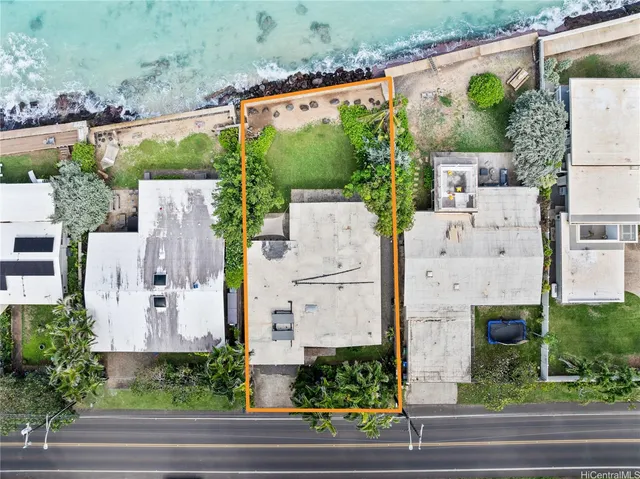 an aerial view of a house with a garden and plants