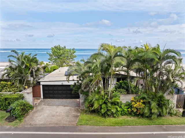 a view of a chair and table in backyard of the house