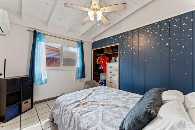 a bed room with a bed and a television