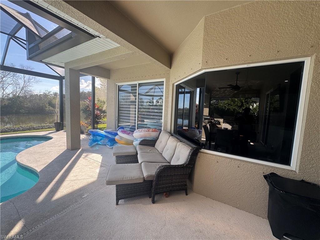 18445 Royal Hammock Boulevard Naples, FL 34114 - Photo 13 of 50 a living room with furniture and a fireplace