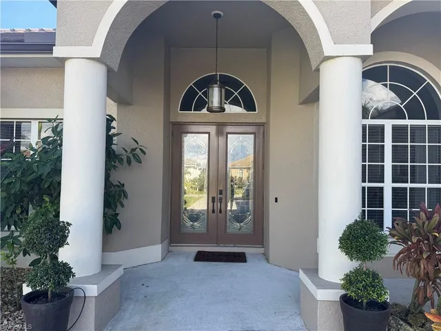 a view of a patio with a dining table and chairs