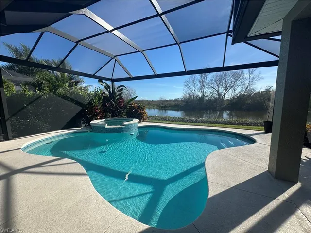 a view of a dining room with furniture a chandelier and wooden floor