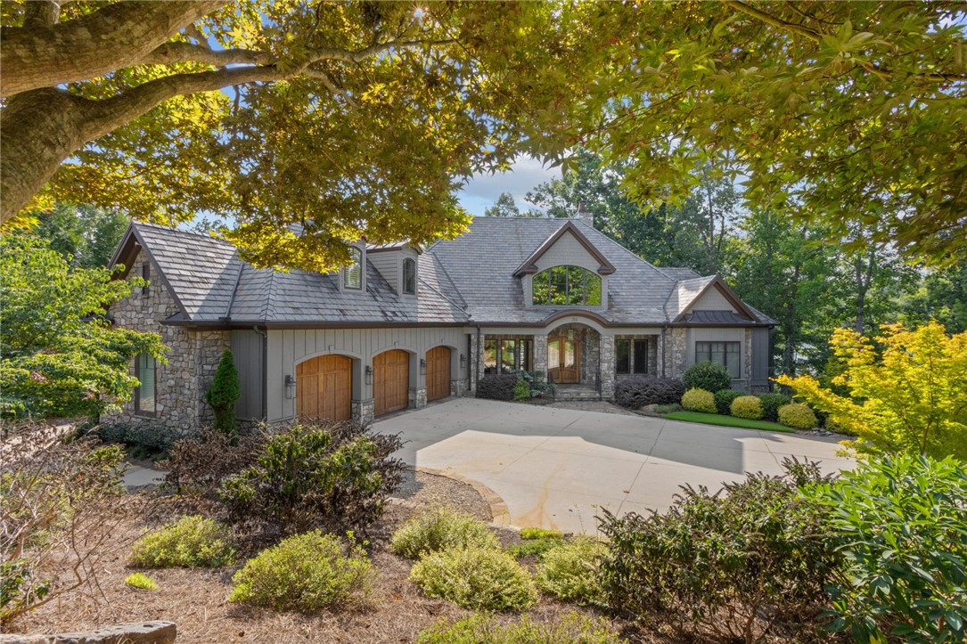 314 Palmer Way Sunset, SC 29685 - Photo 1 of 48 A grand stone and wood facade welcomes you to this woodland retreat, set amidst lush, mature landscaping.