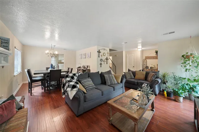 a living room with furniture or wooden floor and a chandelier