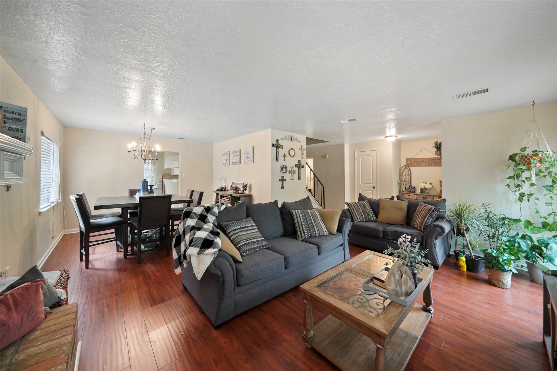 a living room with furniture or wooden floor and a chandelier