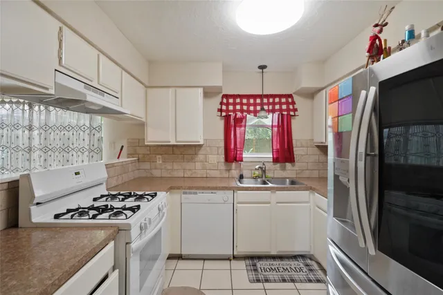 a kitchen with a sink stove and refrigerator