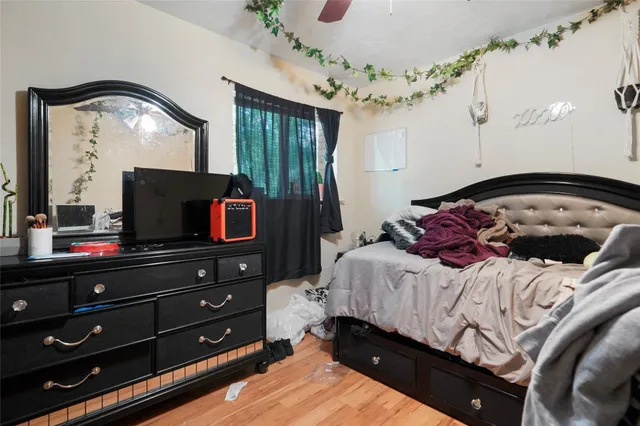 a bedroom with a bed and a mirror