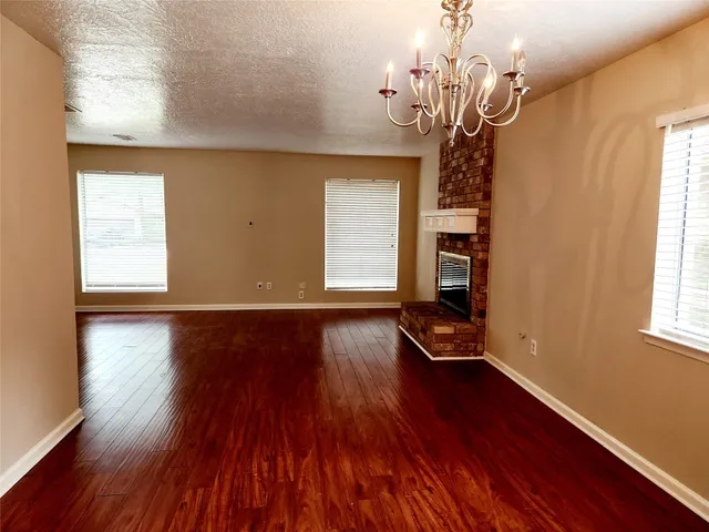 a view of a room with wooden floor and windows