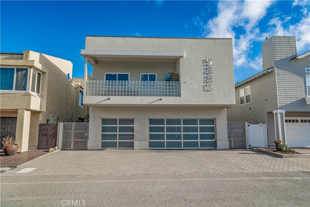 a front view of a house with a parking space