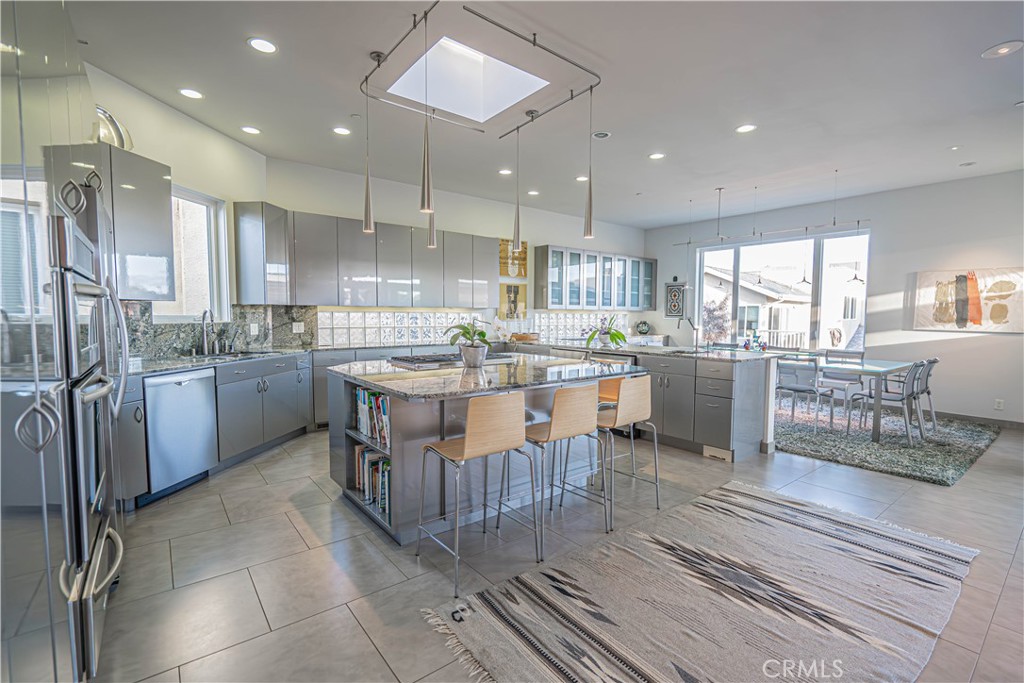 5220 Terramar Way Oxnard, CA 93035 - Photo 55 of 75 a kitchen with stainless steel appliances granite countertop a sink counter space cabinets and a large window