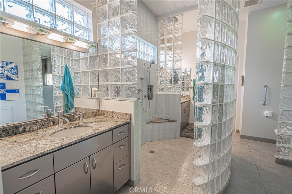 5220 Terramar Way Oxnard, CA 93035 - Photo 61 of 75 a bathroom with a granite countertop sink and a mirror