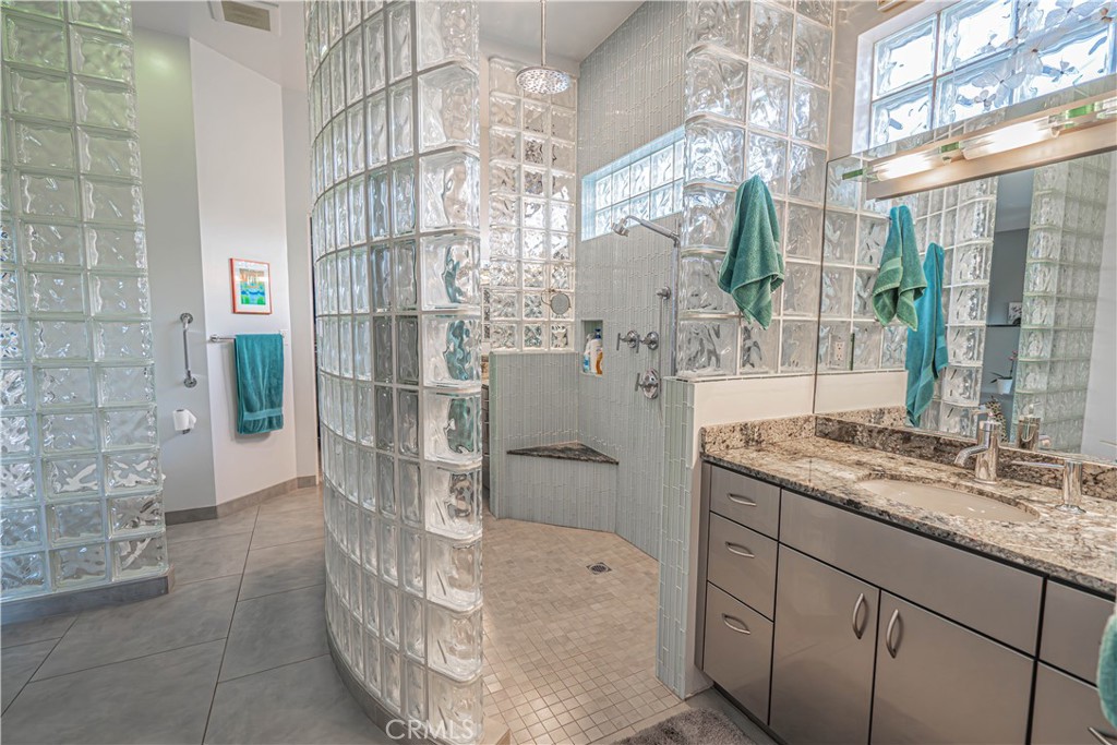 5220 Terramar Way Oxnard, CA 93035 - Photo 65 of 75 a bathroom with a granite countertop shower a sink and mirror