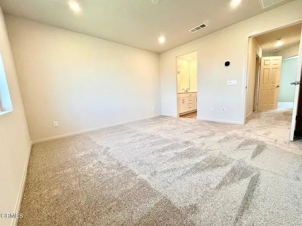 a spacious bathroom with a shower sink and mirror