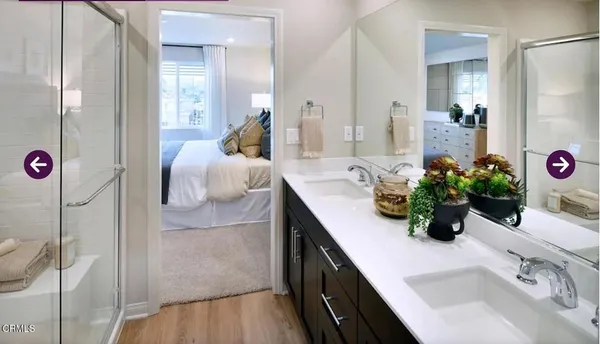 a bathroom with a sink a vanity and a shower