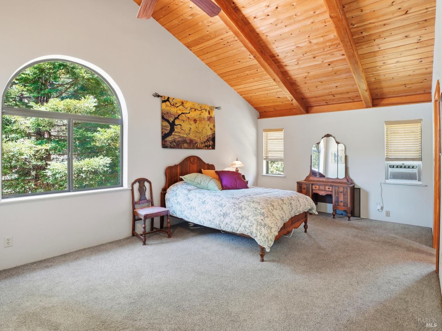 31397 Seaview Road Cazadero, CA 95421 - Photo 19 of 47 a bedroom with a bed a dresser next to a window