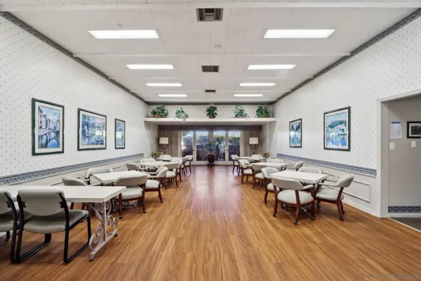 a room with pool table and windows