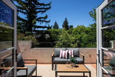 a view of a chairs and table in patio