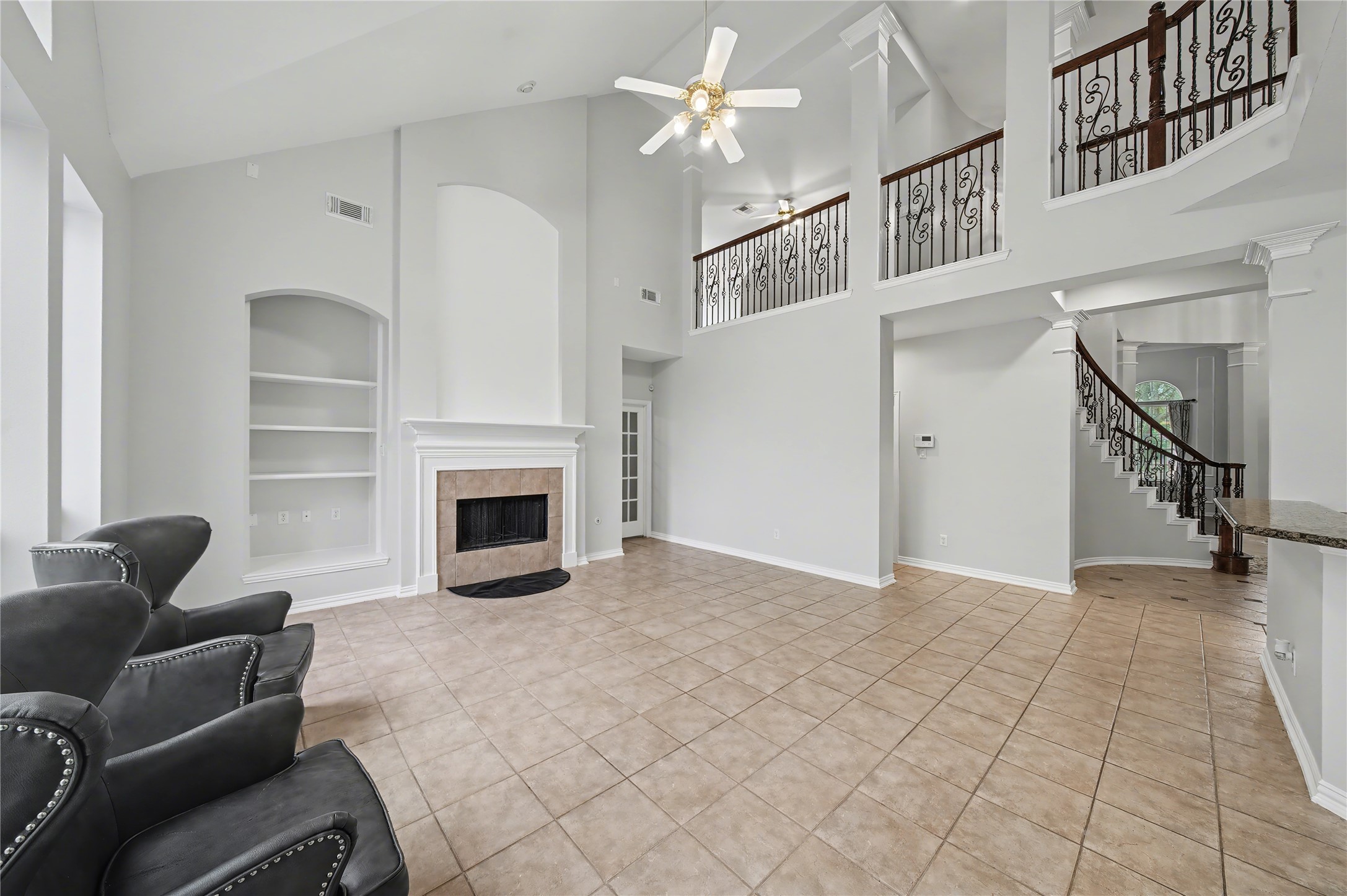 5403 Emerald Pointe Lane Sugar Land, TX 77479 - Photo 25 of 50 a view of a livingroom with a ceiling fan a fireplace and a window