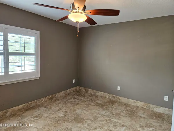 a living room with furniture gym equipment and a window