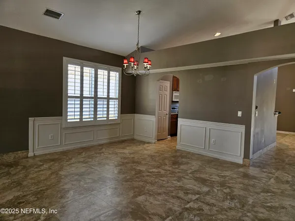 a kitchen with stainless steel appliances kitchen island granite countertop a sink dishwasher stove top oven and cabinets with wooden floor