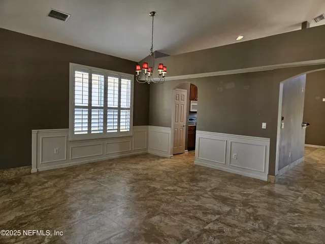 a kitchen with stainless steel appliances kitchen island granite countertop a sink dishwasher stove top oven and cabinets with wooden floor