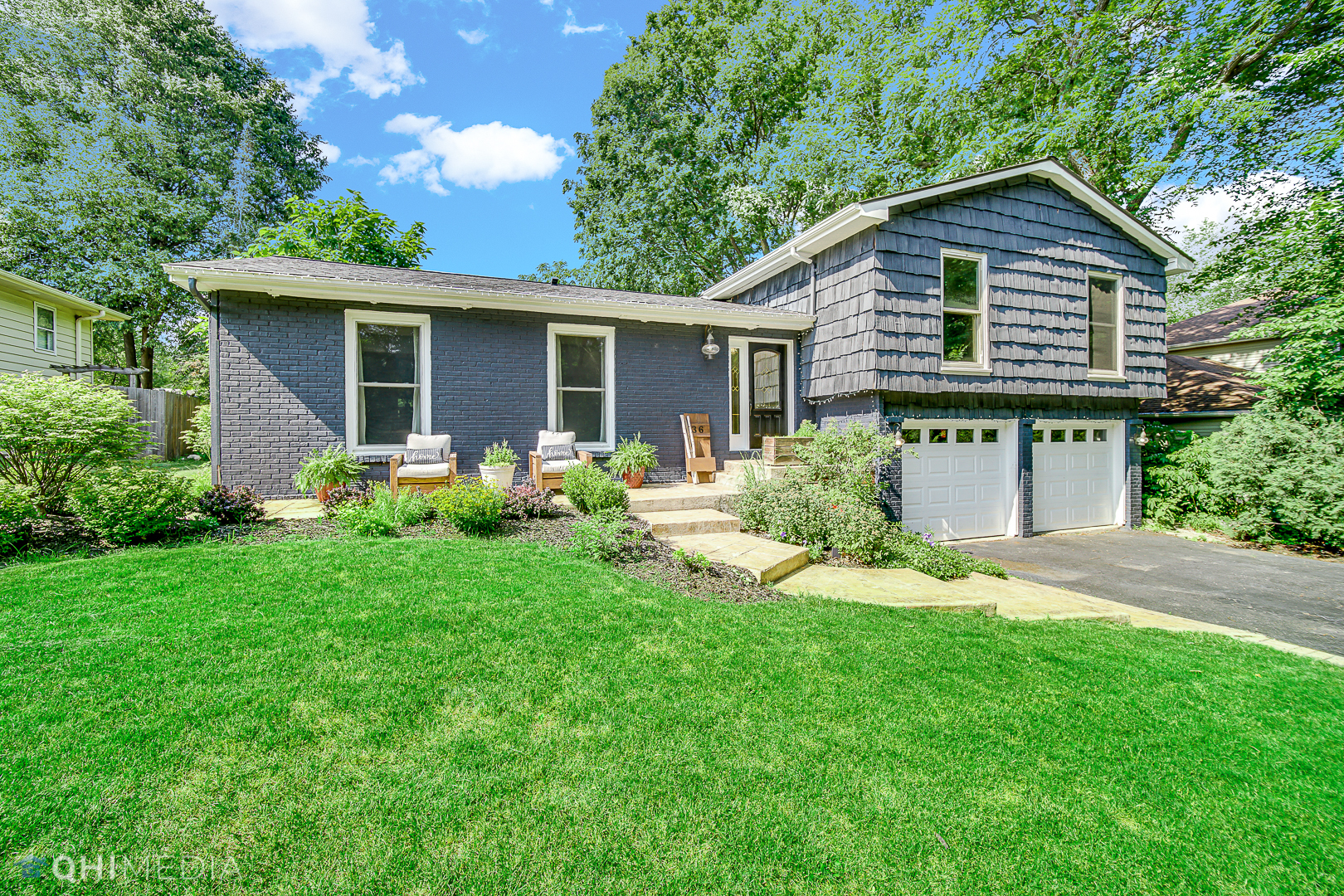 a front view of house with yard and green space