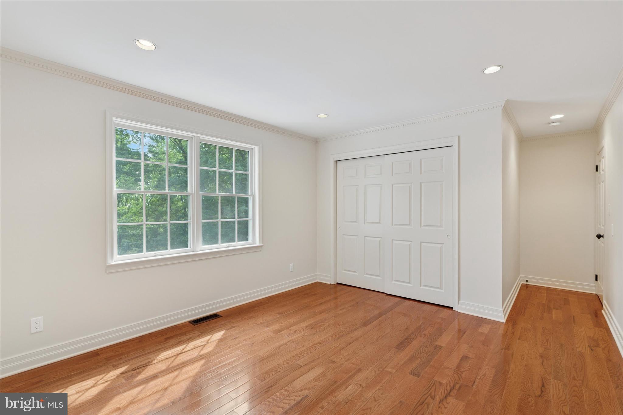 2824 Hill Road Green Lane, PA 18054 - Photo 19 of 40 an empty room with wooden floor and windows