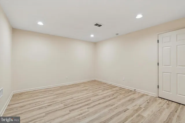 a view of room with wooden floor and fan