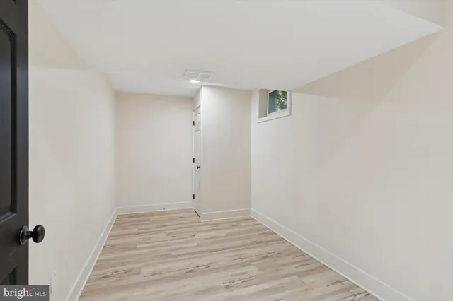 a view of a room with wooden floor