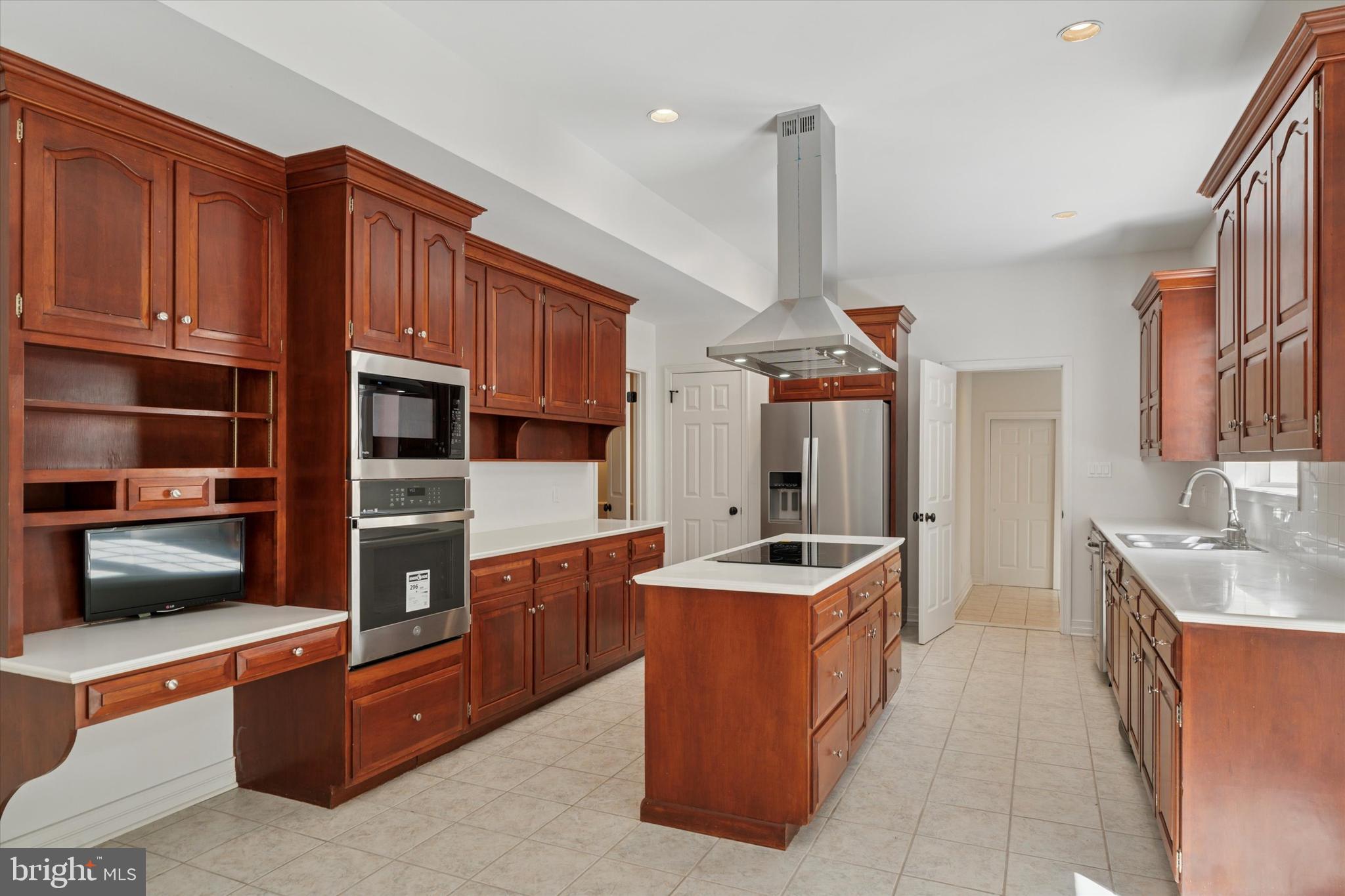 2824 Hill Road Green Lane, PA 18054 - Photo 7 of 40 a kitchen with stainless steel appliances granite countertop a stove a sink and a microwave