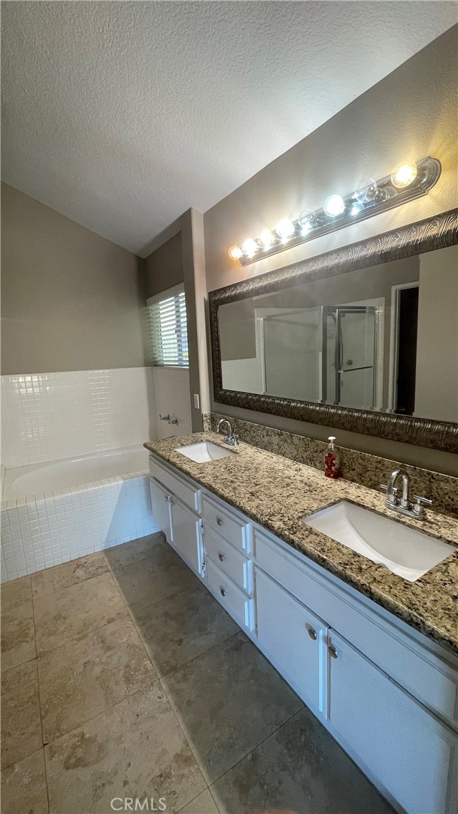 26 Reata Rancho Santa Margarita, CA 92688 - Photo 8 of 15 a bathroom with double vanity and a mirror