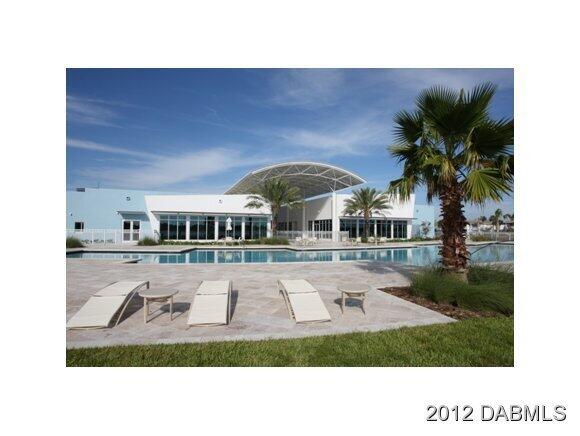 241 Riverside Drive, Unit 905 Holly Hill, FL 32117 - Photo 6 of 8 a front view of a house with garden