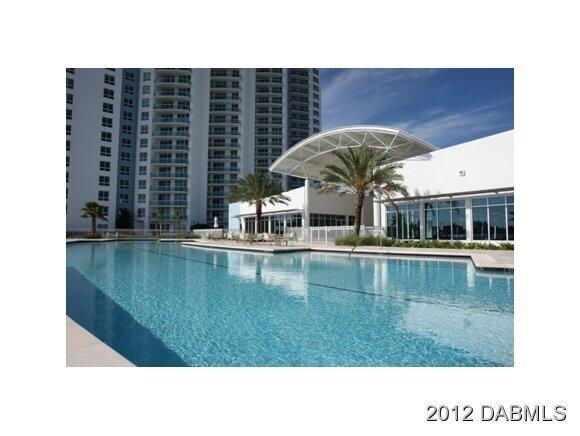 241 Riverside Drive, Unit 905 Holly Hill, FL 32117 - Photo 8 of 8 a swimming pool with outdoor seating